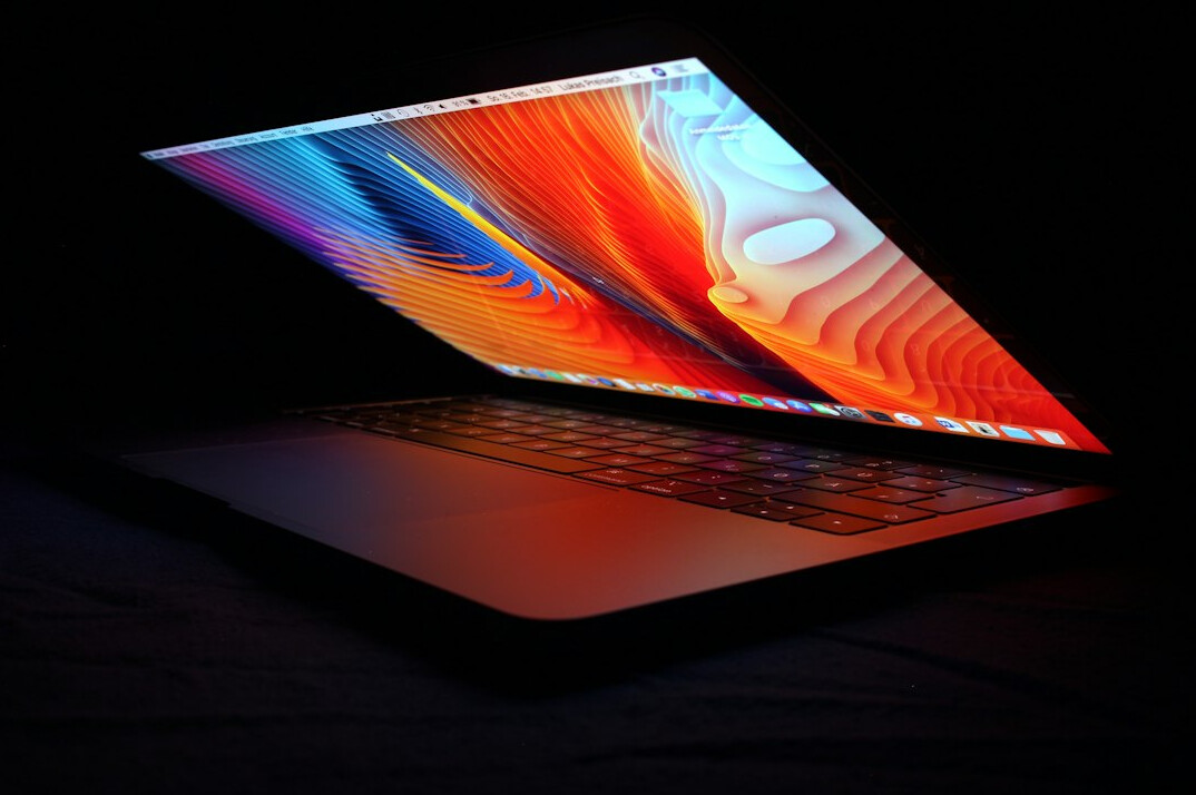 Laptop screen showing colorful web development code